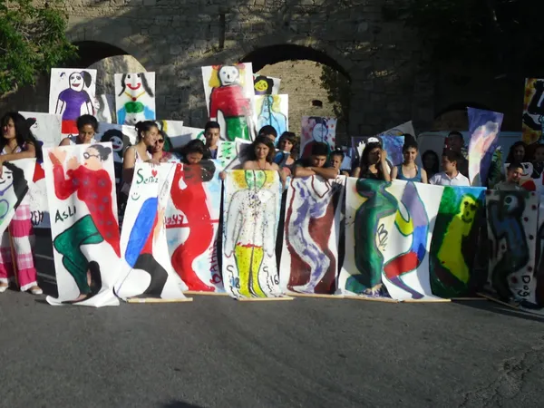 The big portraits the young people painted, by the old walls