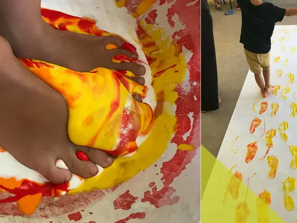 Painted footprints along a long roll of paper